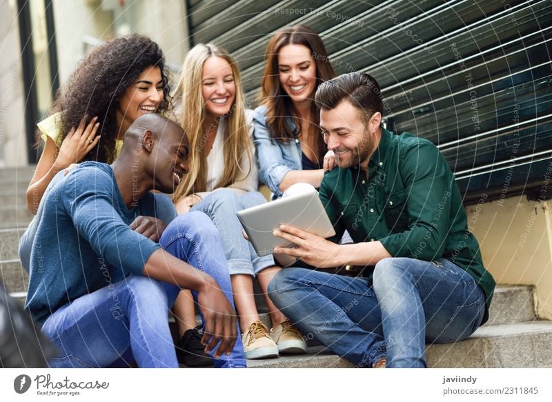 Multi-ethnic group of people looking at a tablet computer Lifestyle Joy Beautiful Young woman Youth (Young adults) Young man Woman Adults Man Friendship 5