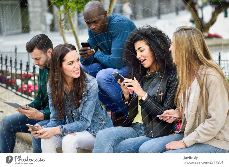 Multi-ethnic group of young people using smartphone Lifestyle Joy Summer Telephone Computer Technology Human being Young woman Youth (Young adults) Young man