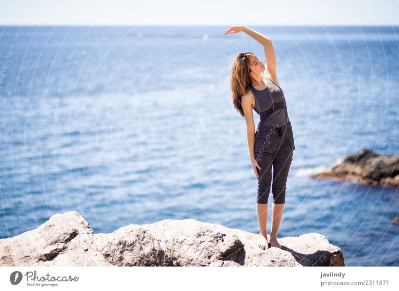 Young woman doing yoga in the beach. Lifestyle Wellness Relaxation Meditation Summer Beach Ocean Sports Yoga Human being Youth (Young adults) Woman Adults 1