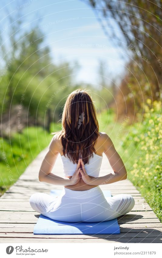 Woman doing yoga in nature. Lotus figure on wooden road. Lifestyle Beautiful Body Relaxation Meditation Summer Sports Yoga Human being Young woman