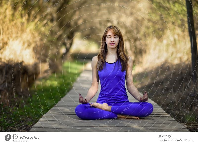 Young woman doing yoga in nature. Lotus figure. Lifestyle Beautiful Body Relaxation Meditation Summer Sports Yoga Human being Youth (Young adults) Woman Adults