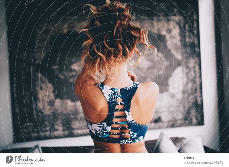 Back view of woman wearing sports bra Lifestyle Happy Beautiful Body Wellness Relaxation Meditation Yoga Woman Adults Fitness Smiling White indoor Home Practice