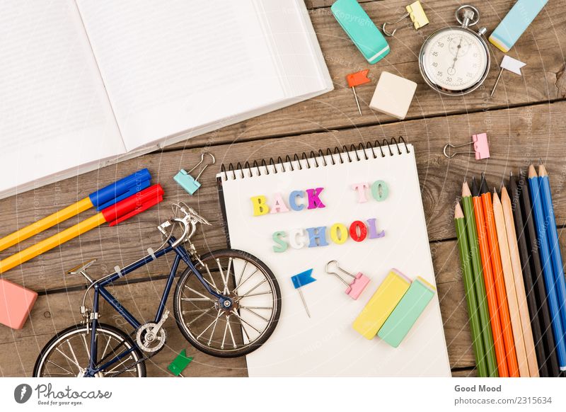 inscription of "back to school", bicycle model, stopwatch, book Table Child School Academic studies Office Tool Infancy Book Paper Wood Bright background Set