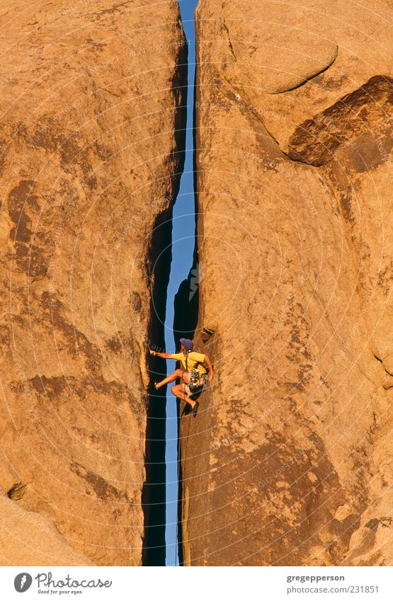 Rock climber clinging to a cliff. Adventure Climbing Mountaineering Success Rope Man Adults 1 Human being Nature Fitness Athletic Tall Bravery Self-confident