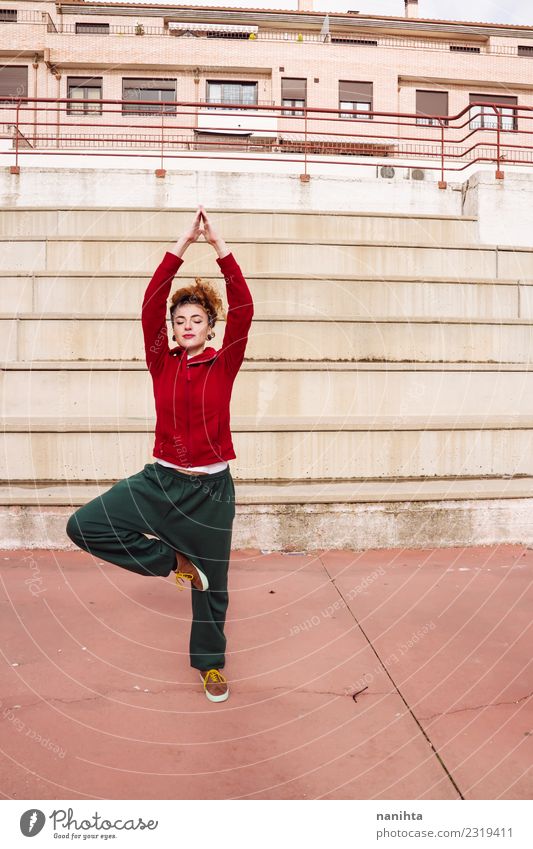 Young woman doing a yoga pose in the street Lifestyle Style Body Healthy Health care Athletic Fitness Wellness Harmonious Relaxation Meditation Sports