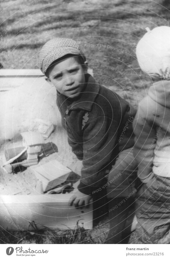 little man in a sandbox Child Playing Sandpit Brothers and sisters Black & white photo Looking Shadow