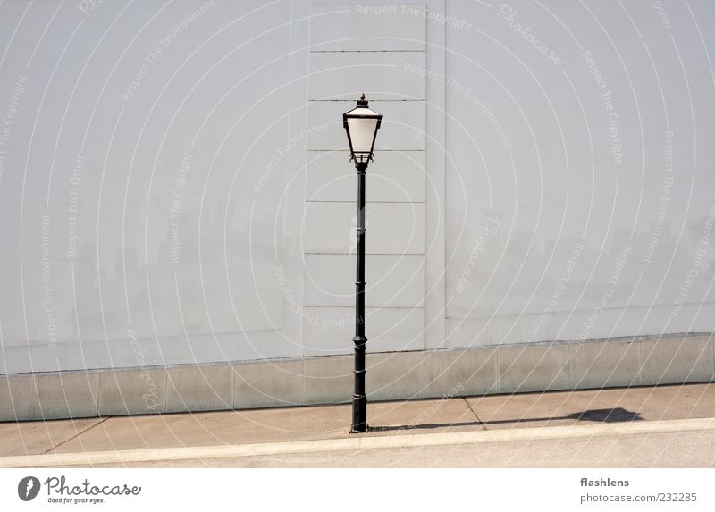 The wall in the back Old town Deserted Architecture Wall (barrier) Wall (building) Street lighting Gray Black White Emotions Unwavering Symmetry Exterior shot