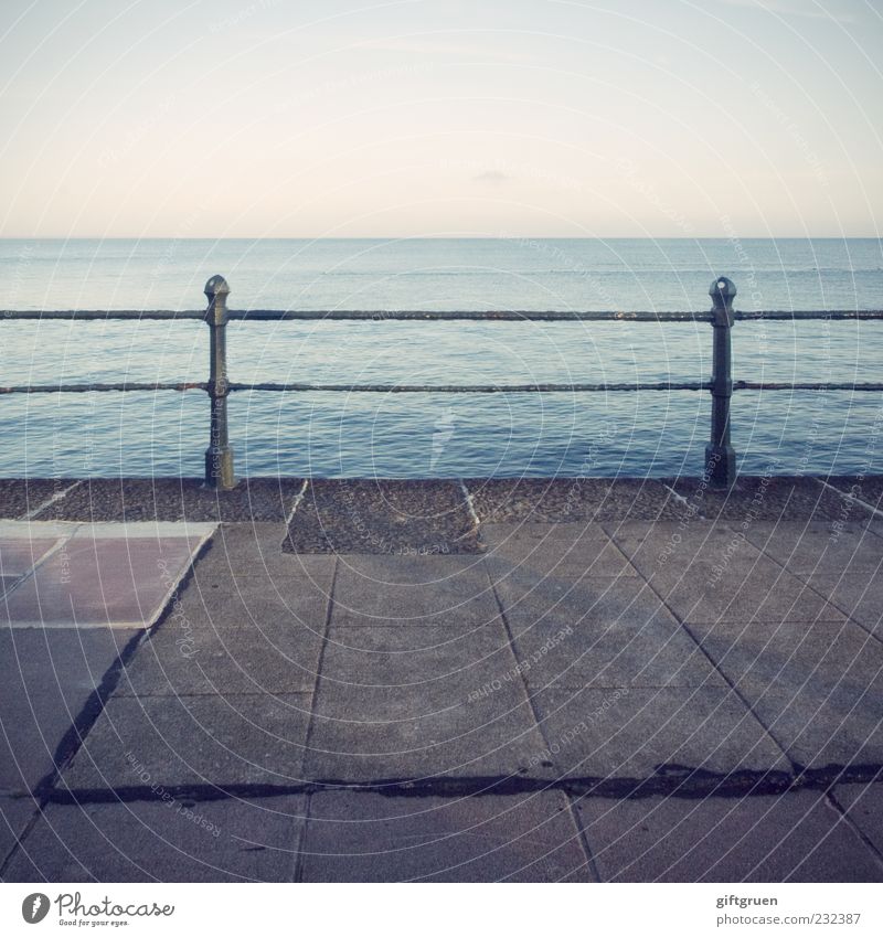 Up to here and no further Environment Nature Elements Water Sky Cloudless sky Beautiful weather Coast Ocean Far-off places Barrier Fence Pole Horizon Stone slab