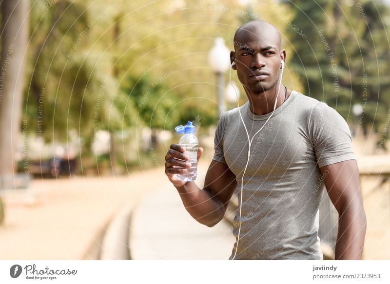 Young black man drinking water before running outdoors Drinking Bottle Lifestyle Body Sports Jogging Human being Masculine Young man Youth (Young adults) Man