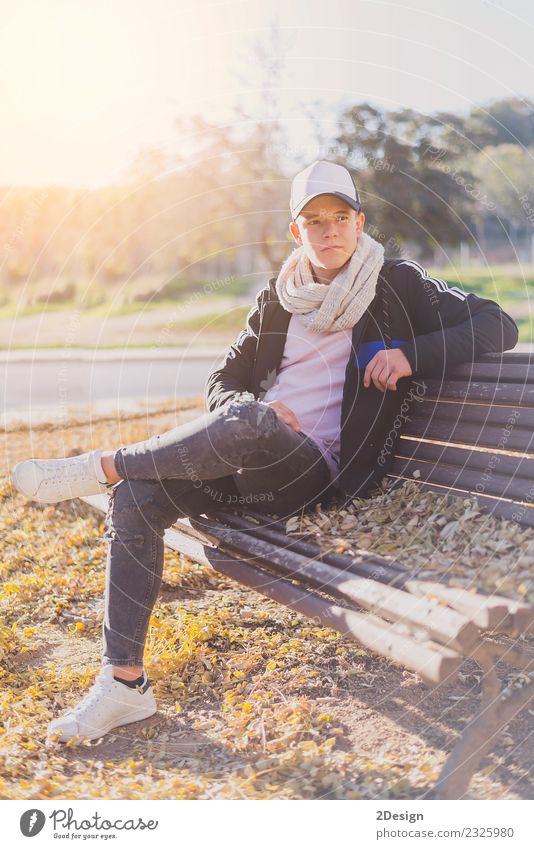 Stylish teenager sitting on a wooden bench Lifestyle Happy Calm Schoolchild Academic studies PDA Human being Boy (child) Man Adults Youth (Young adults) Autumn