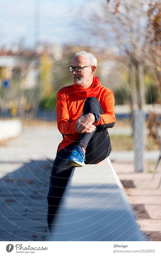 Senior runner man sitting after jogging in a park Lifestyle Happy Relaxation Calm Leisure and hobbies Summer Music Sports Human being Man Adults Nature Plant