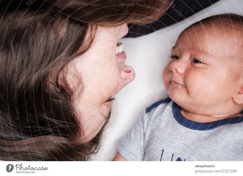 Portrait of beautiful mum playing with her 3 months old Lifestyle Joy Happy Beautiful Contentment Decoration Bedroom Human being Baby Boy (child) Woman Adults