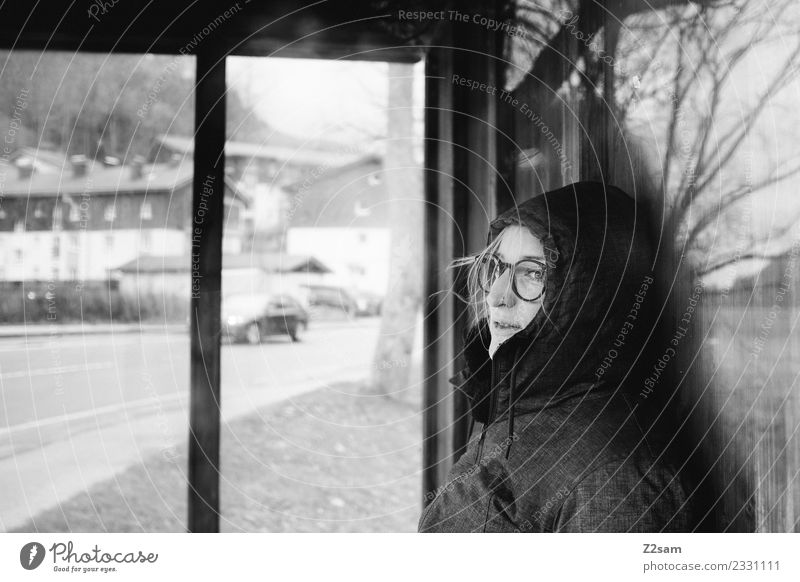 Woman waiting for bus Feminine Young woman Youth (Young adults) 18 - 30 years Adults Village Town Means of transport Traffic infrastructure Hooded (clothing)