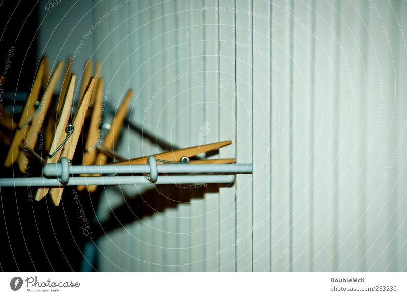 stapling Heater Heating Wood Metal To hold on Sharp-edged Blue Yellow Green Clothes peg Cotheshorse Deserted Holder Subdued colour Interior shot Close-up Detail