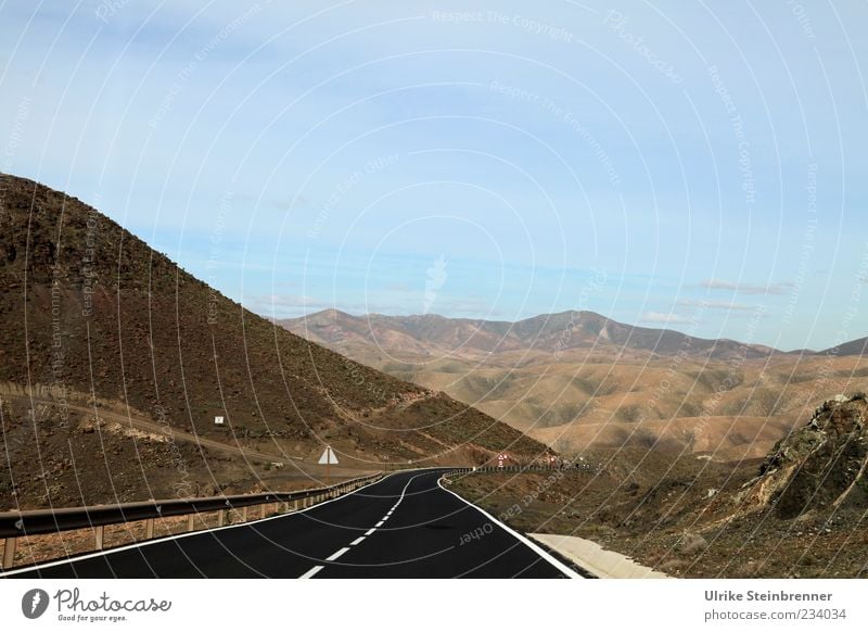 Curving around volcanoes Far-off places Mountain Nature Landscape Earth Beautiful weather Plant Bushes Moss Hill Rock Volcano Island Fuerteventura Spain