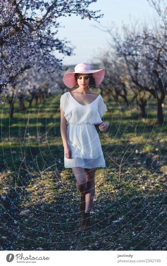 Young woman in almond flowered field in spring time Style Happy Beautiful Hair and hairstyles Face Human being Feminine Youth (Young adults) Woman Adults 1