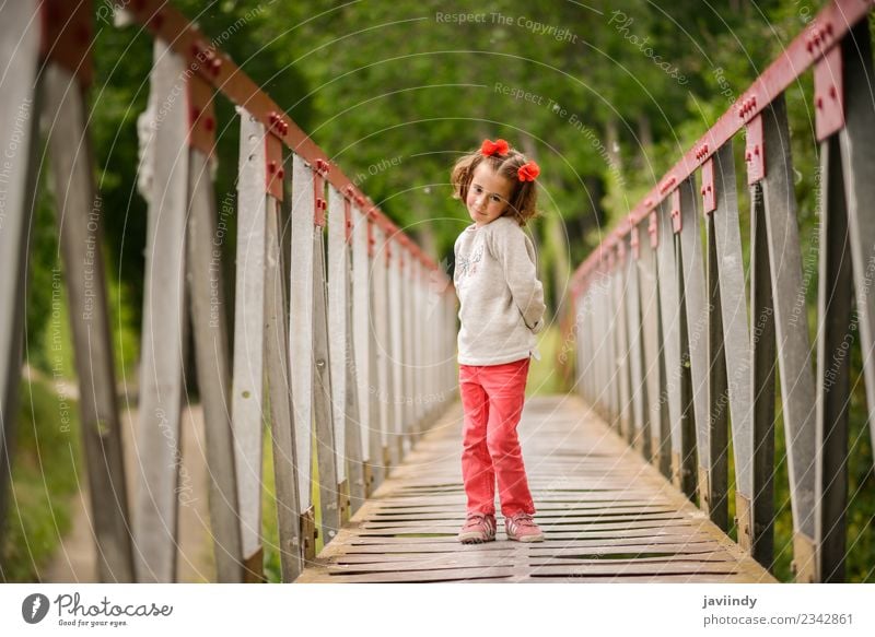 Cute little girl having fun in a rural bridge Joy Happy Beautiful Life Playing Child Human being Baby Girl Woman Adults Infancy 1 3 - 8 years Nature Flower