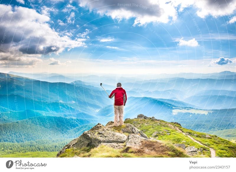 Young man on the top of mountain taking picture with smartphone Lifestyle Joy Beautiful Leisure and hobbies Vacation & Travel Tourism Trip Adventure