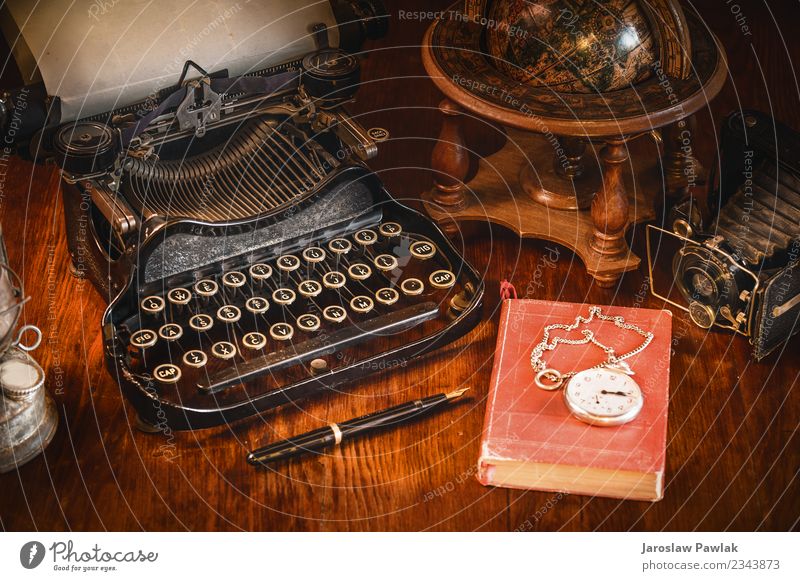 Traditional and old way of writing messages and taking photos, typewriter, camera, watch, pen, Vintage lamp on the desk White ancient antique background black