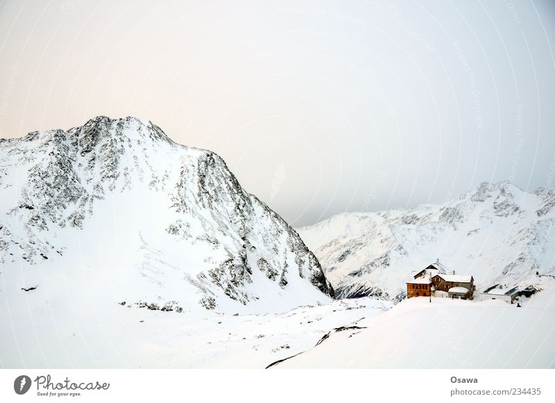 House in the mountains Mountain Rock Peak Snowcapped peak Mountain ridge Alps Winter White Cold Sky Twilight House (Residential Structure) Hut refuge Monochrome