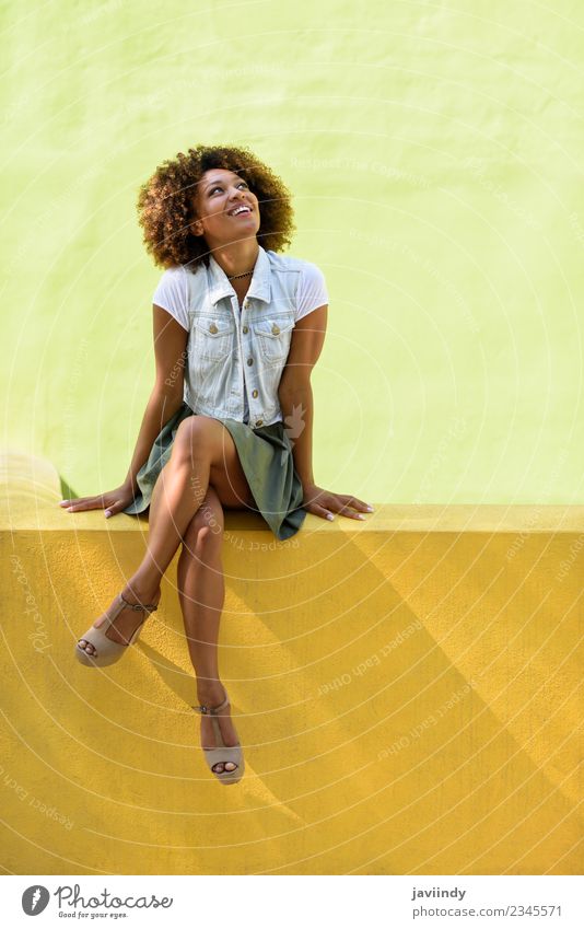 Young black woman, afro hairstyle, sitting on a wall smiling. Lifestyle Style Happy Beautiful Hair and hairstyles Face Human being Young woman