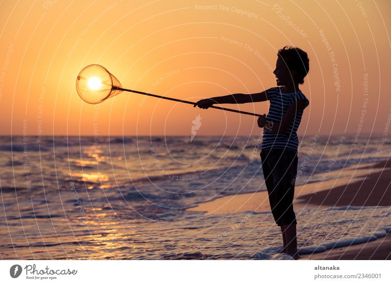 One happy little boy playing on the beach at the sunset time. Lifestyle Joy Happy Beautiful Relaxation Leisure and hobbies Playing Vacation & Travel Trip