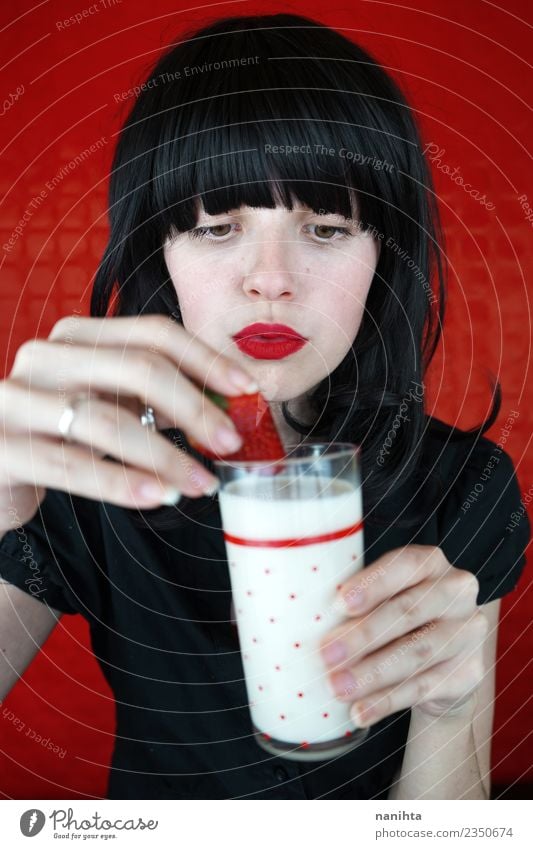 Young woman eating strawberries and milk Food Fruit Strawberry Nutrition Eating Vegetarian diet Beverage Cold drink Milk Lifestyle Design Beautiful