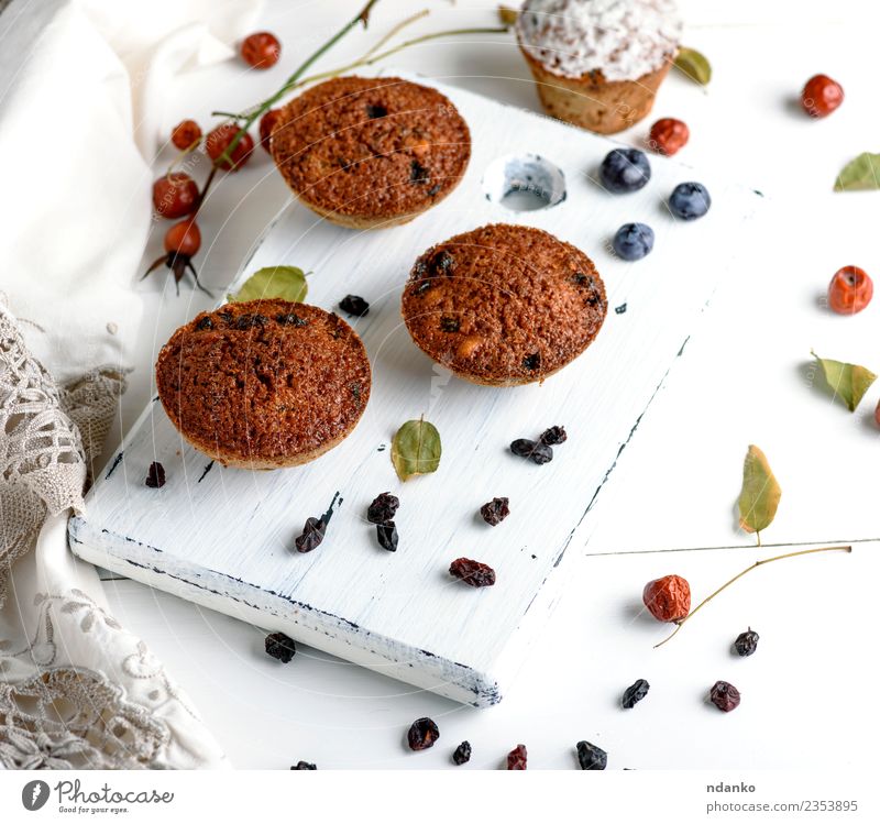 cupcakes with dried fruits Cake Dessert Nutrition Breakfast Table Wood Eating Fresh Small Above Brown White background Baking Bakery chocolate cooking Cupcake