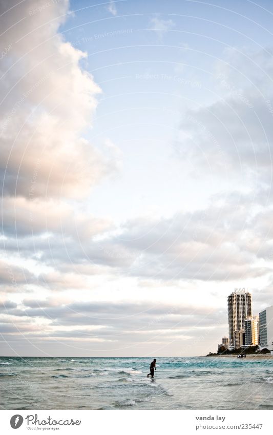 Miami Beach Sportsperson Jogging Human being 1 Environment Clouds Beautiful weather Ocean Florida USA House (Residential Structure) High-rise Walking Loneliness