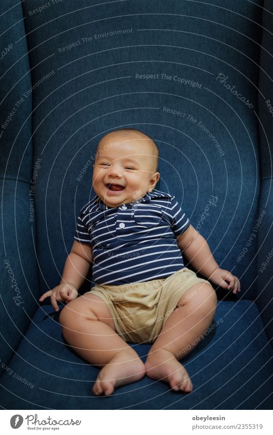 a happy baby boy sitting on a sofa and smilling Lifestyle Joy Happy Beautiful Leisure and hobbies Living room Child Human being Baby Toddler Boy (child) Infancy