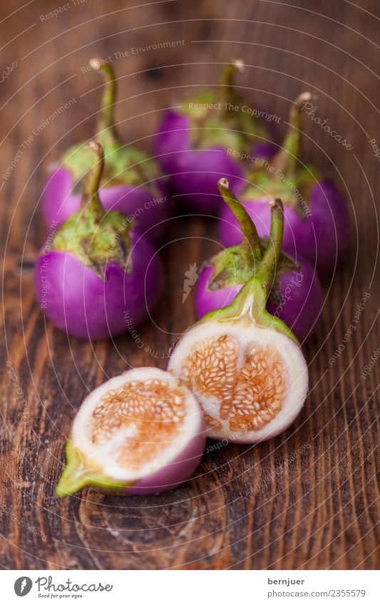 Asian aubergines on dark wood Food Vegetable Nutrition Organic produce Vegetarian diet Diet Nature Plant Wood Dark Fresh Small Brown Violet White Aubergine Heap