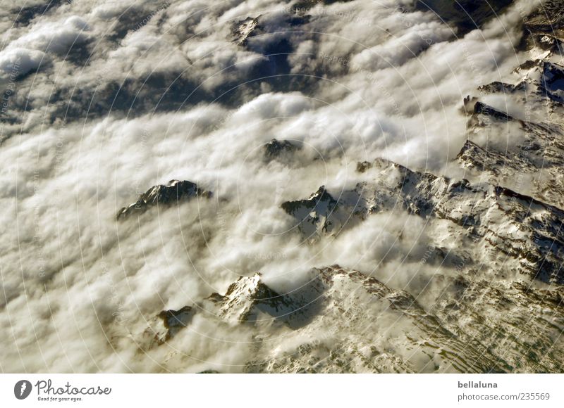 Pyrenean Alps Nature Landscape Sky Clouds Storm clouds Sunlight Winter Beautiful weather Ice Frost Snow Rock Mountain Peak Snowcapped peak Tenerife Pyrenees