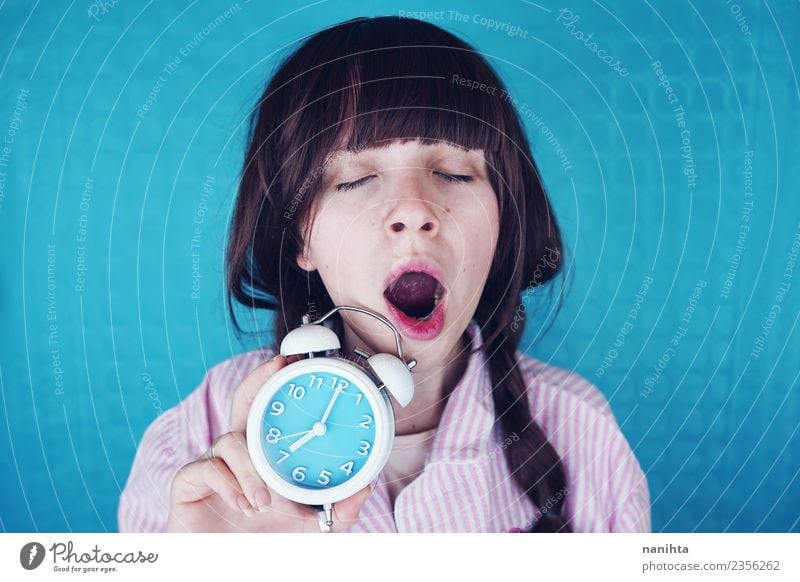 Young woman yawning and holding a clock at morning Lifestyle Style Healthy Human being Feminine Youth (Young adults) 1 18 - 30 years Adults Night dress