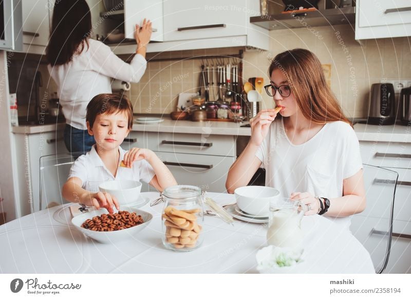 happy family having breakfast at home Breakfast Tea Lifestyle Joy Happy Kitchen Child Mother Adults Sister Family & Relations Youth (Young adults) Smiling