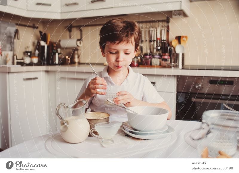 kid boy having breakfast at home in modern white kitchen Breakfast Lifestyle Joy Happy Kitchen Child School Boy (child) Smiling Together Modern Cute White