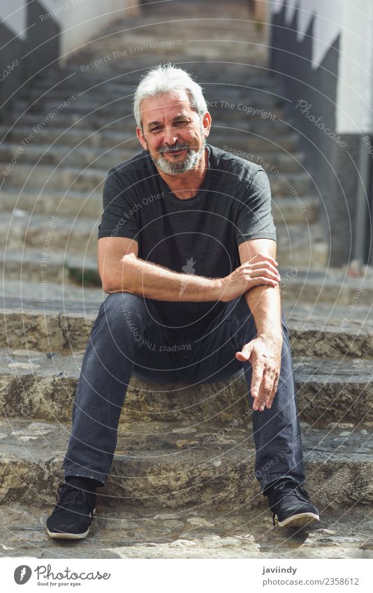 Mature man sitting on steps on steps smiling. Lifestyle Happy Human being Man Adults Male senior Senior citizen 1 45 - 60 years 60 years and older Street