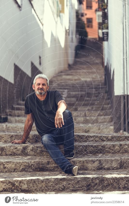 Portrait of a mature man sitting on steps in the street Lifestyle Happy Human being Masculine Man Adults Male senior Senior citizen 1 45 - 60 years Street