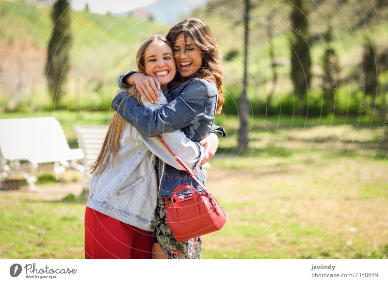 Two happy girls hugging in urban park. Lifestyle Joy Happy Beautiful Human being Young woman Youth (Young adults) Woman Adults Friendship 2 18 - 30 years Park