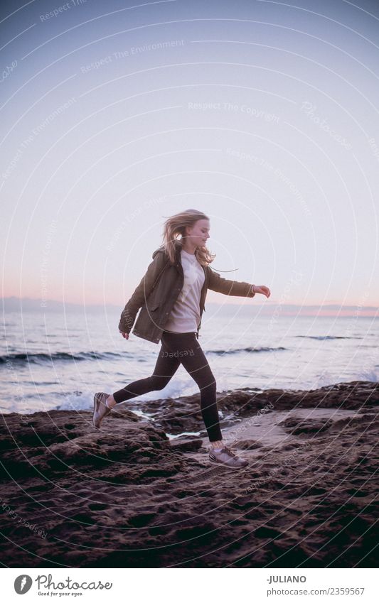 young woman is jumping at the beach Beach Dusk Emotions Young woman Happy Life Lifestyle Spain Summer Sun Sunset Warmth Action Adventure Communicate Freedom