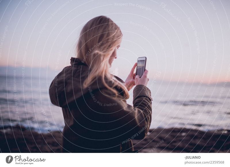 Young woman is taking picture of sunset at the beach Beach Dusk Emotions Girl Happy Life Lifestyle Spain Summer Sun Sunset Warmth Adventure Communicate