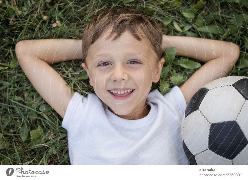 Portrait of a young boy with soccer ball. Concept of sport. Lifestyle Joy Happy Relaxation Leisure and hobbies Playing Summer Sports Soccer Child Human being