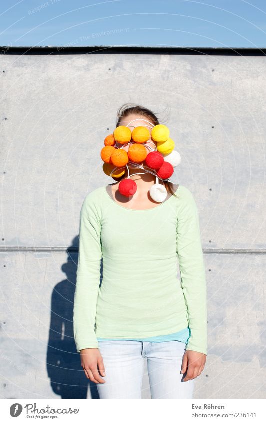 I see red. And yellow. Young woman Youth (Young adults) Cloudless sky Wall (barrier) Wall (building) Roof Jeans Sweater Fairy lights Stand Exceptional Funny