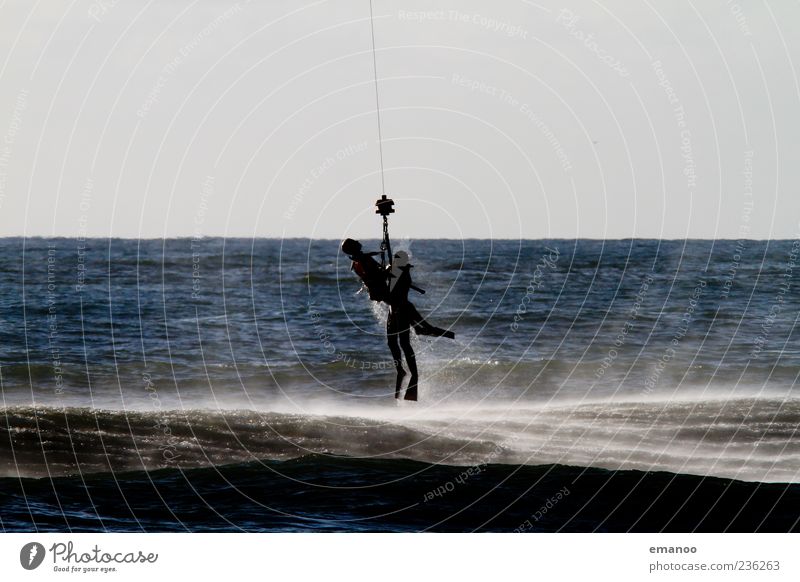 at the last second Ocean Human being 2 Water Flying Blue Bravery Determination Rescue Rope water rescue Accident Colour photo Exterior shot Detail