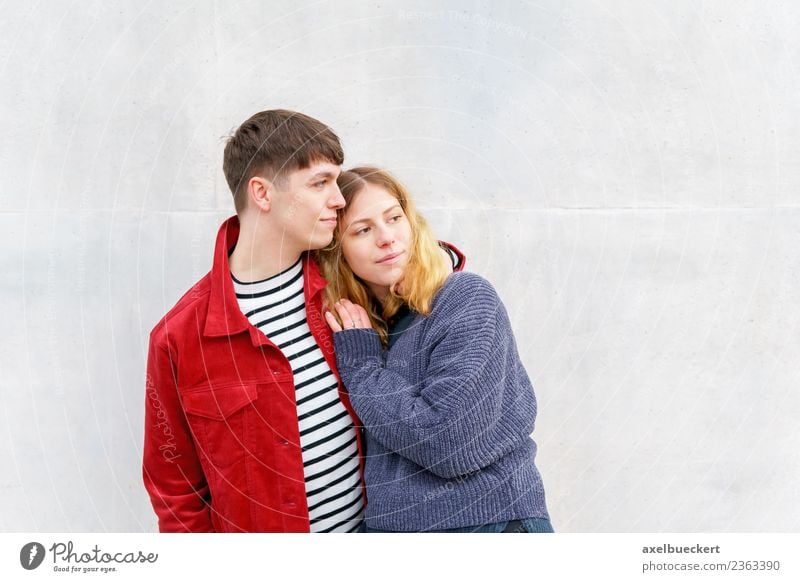 young loving couple standing in front of the concrete wall Lifestyle Human being Young woman Youth (Young adults) Young man Woman Adults Man Friendship Couple