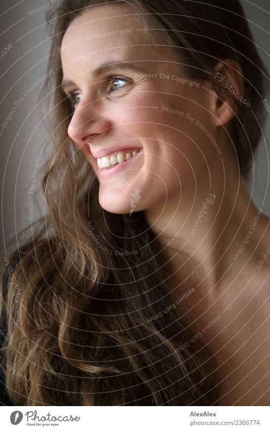 Portrait of laughing beautiful young woman with long brunette hair and dimples Lifestyle Joy pretty Hair and hairstyles Face Well-being Young woman