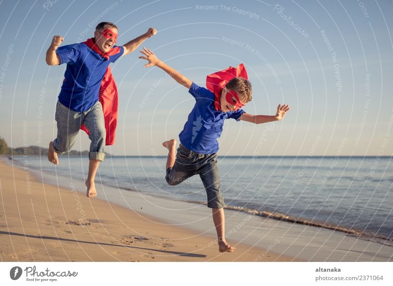 Father and son playing superhero on the beach at the day time. Lifestyle Joy Happy Relaxation Leisure and hobbies Playing Vacation & Travel Adventure Freedom