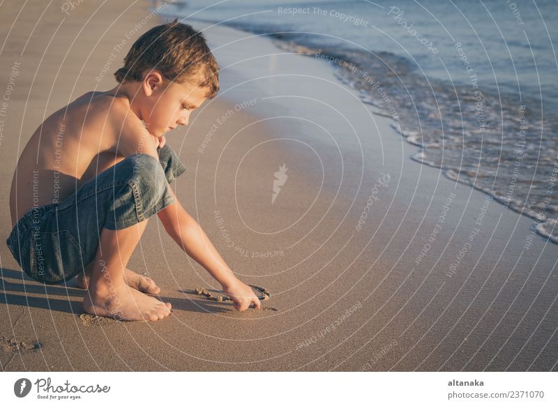 One happy little boy playing on the beach at the day time. Lifestyle Joy Happy Beautiful Relaxation Leisure and hobbies Playing Vacation & Travel Freedom