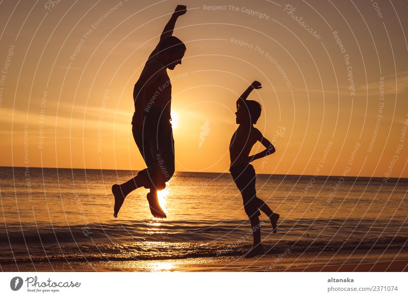 Father and son playing on the beach at the sunset time. Lifestyle Joy Happy Leisure and hobbies Vacation & Travel Trip Adventure Freedom Camping Summer Sun