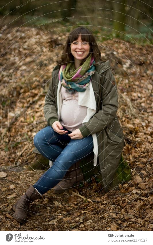 Pregnant woman sits in the forest Lifestyle Leisure and hobbies Human being Feminine Young woman Youth (Young adults) Woman Adults Forest Autumn Nature