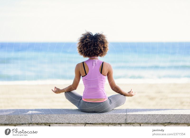 Black woman, afro hairstyle, doing yoga in the beach Lifestyle Beautiful Hair and hairstyles Wellness Relaxation Meditation Leisure and hobbies Beach Ocean